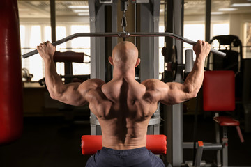 Fototapeta na wymiar Muscular man training in gym