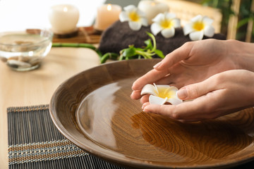 Young woman undergoing spa manicure treatment in beauty salon