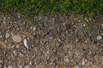 Ground road with fine gravel and grass. View from the top. Close-up Background