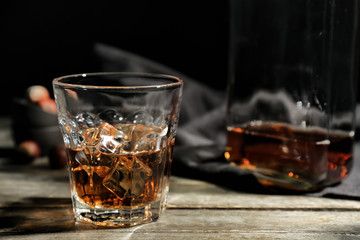 Glass of whiskey on wooden table