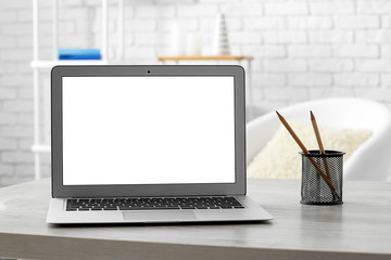 Fototapeta premium Modern laptop on table in room