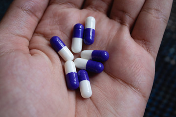 Medicine pills or capsules in hand, palm or fingers. Drug prescription for treatment medication....