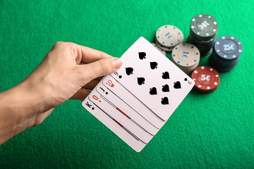 Young woman playing poker in casino