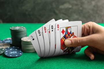 Young woman playing poker in casino, closeup