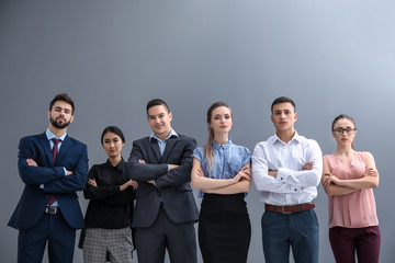 Team of young people on grey background