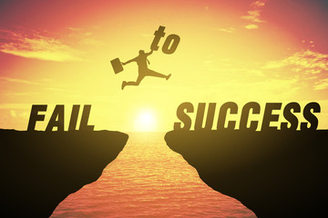 Silhouette of business man jump between cliff. keep go on to success concept at FAIL TO SUCCESS over a beautiful high view sunrise sea background. ready in 2019 years. GO TO 2019 YEAR CONCEPT