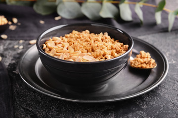 Bowl with tasty granola and yogurt on grunge table
