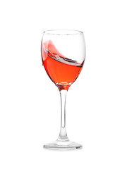 Glass with red splashing wine on white background