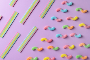 Assortment of tasty candies on color background