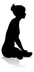 A silhouette of a woman in a yoga or pilates pose 