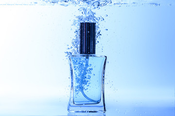 Obraz na płótnie Canvas Bottle of perfume in clear water