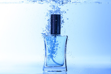 Bottle of perfume in clear water