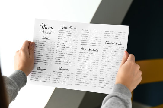 Woman reading menu in cafe