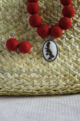 Necklace with a pendant and earrings. Felted wool necklace. Straw background