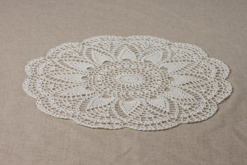 Crocheted round-type napkin. White color. Close-up