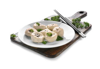 Plate with tasty Chinese dumplings on white background