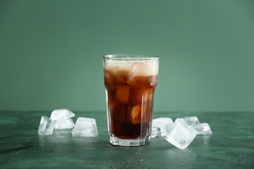Glass of soda with ice on table