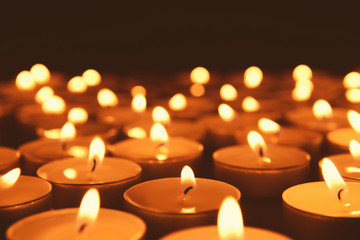 Beautiful burning candles on dark background, closeup