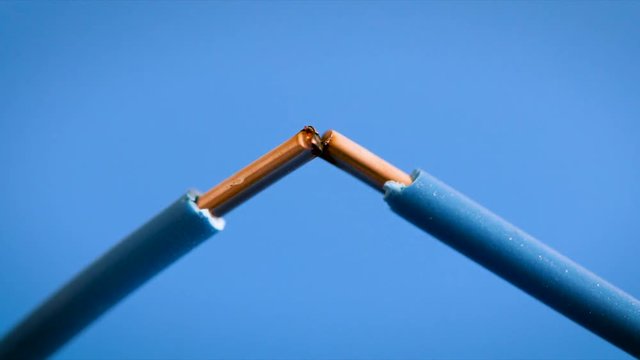 electrical wires sparks on blue background