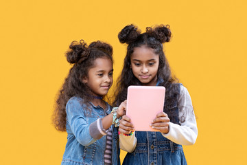 Cute nice girl pointing at the tablet screen