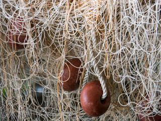 Fishing net with red plastic foam float side view