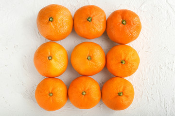 Tasty tangerines on white textured background