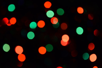 Bokeh. Christmas lights. Holiday background. Garland. Glitter. Defocused sparkles. Festive. New Year backdrop. Blinks. Carnival. Bokeh retro style photo. Multicolor. Colorful.