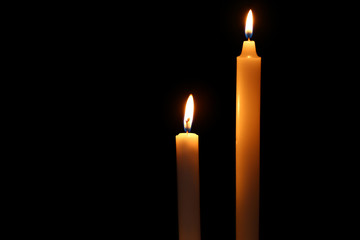Beautiful burning candles on dark background
