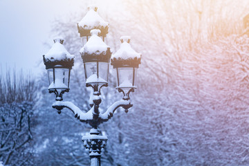 Winter landscape with lamp post under the snow