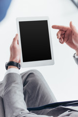 partial view of businessman using digital tablet with blank screen