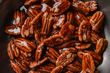 Frying pan with candied pecan nuts, closeup