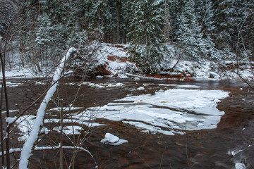 forest river in winter. Amata in Latvia