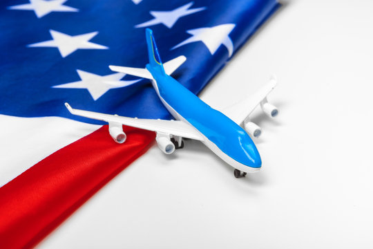 Plastic toy jet plane and flag of USA.