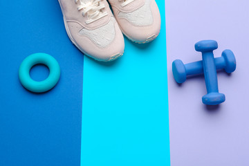 Fototapeta na wymiar Fitness Gym equipment on color background