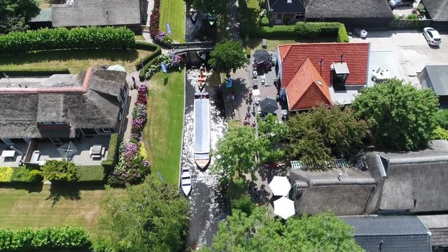 Aerial bird view of busy canal in Giethoorn is town in province of Overijssel Holland and is often referred to as the Venice of the Netherlands because of the popular canals with tourist tour boats 4k
