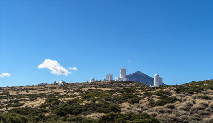 Landscape with sun observatory on the mountains with Teide volcano behind.