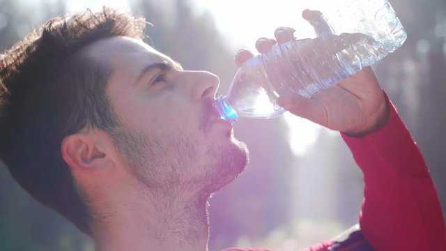 Man drinking water after hard workout