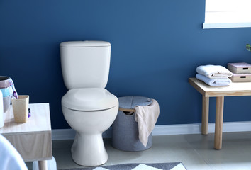 Modern interior of restroom with ceramic toilet bowl