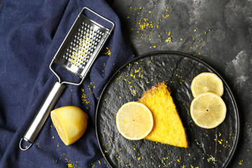 Plate with piece of tasty citrus pie on dark table