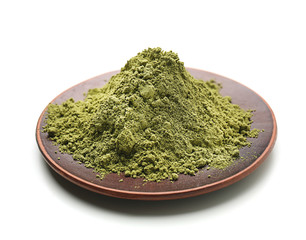 Plate with powdered matcha tea on white background