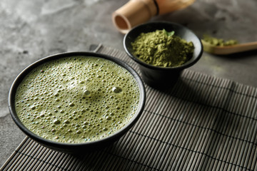 Bowl with matcha tea on table