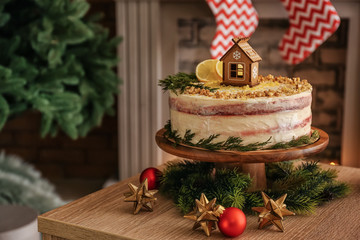 Sweet Christmas cake on table in room