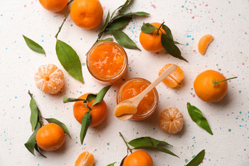 Jars of tasty tangerine jam on light table