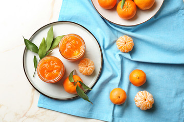 Jars of tasty tangerine jam on light table
