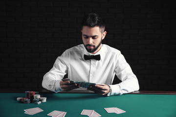 Handsome poker player at table in casino