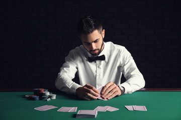 Handsome poker player at table in casino