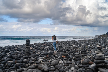Fototapeta na wymiar Many stone stacks on the beach near ocean