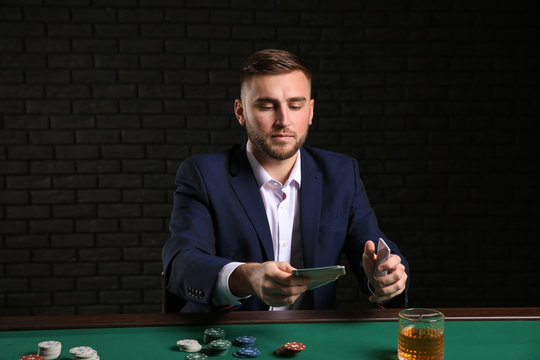Handsome poker player at table in casino