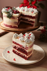 Piece of tasty Christmas cake on wooden table