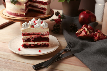Piece of tasty Christmas cake on wooden table